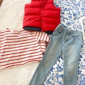 Red Puffer Vest with Striped Sweater and Light Blue Jeans